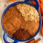 pinterest graphic of overhead of a small blue dish with the four different spices that make up pumpkin pie spice
