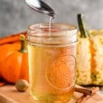 a spoon dripping pumpkin spice syrup into a mason jar full of it - 7