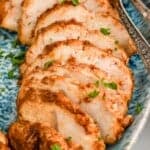 close up of turkey tenderloin recipe sliced and on a platter, garnished with parsley - 17