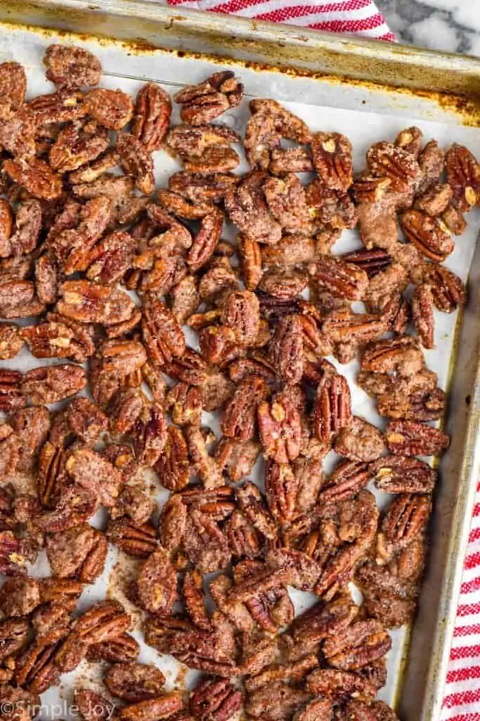 overhead of a rimmed baking sheet with candied pecan recipe