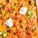 close up overhead view of chicken nachos on a sheet pan