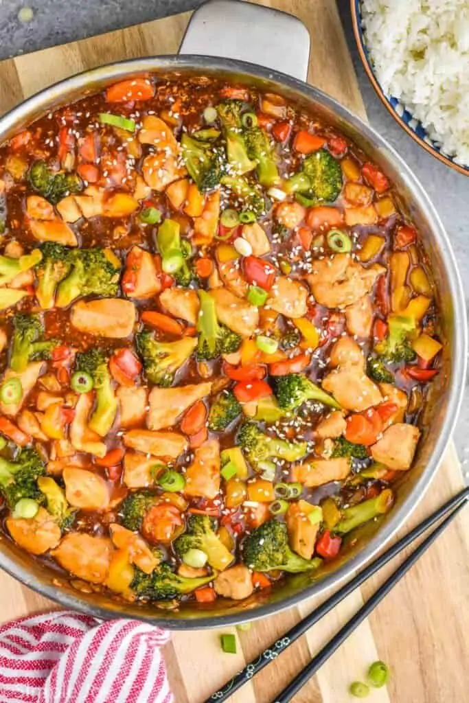 overhead of a skillet with chicken stir fry in it