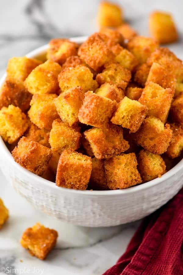 a white bowl full of cornbread croutons