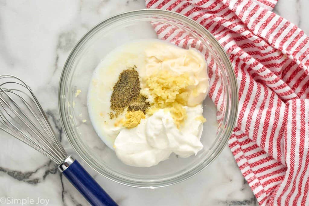 overhead of the ingredients for creamy garlic dressing in a bowl