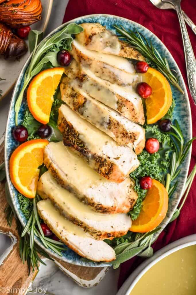overhead of a platter of crockpot turkey breast and gravy 