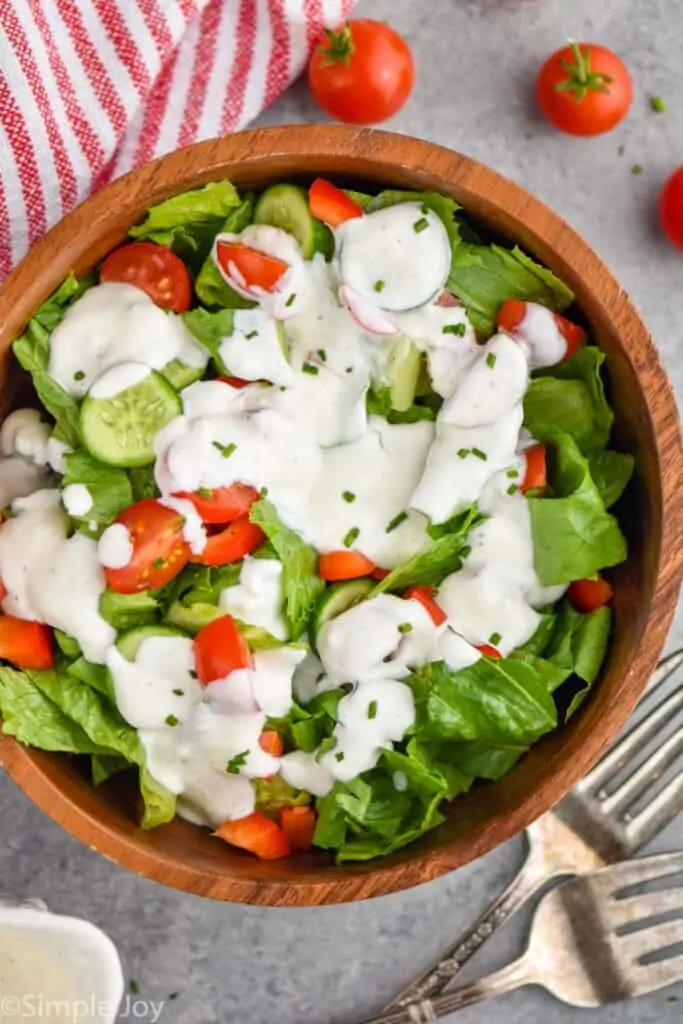 overhead of a garlic dressing recipe on a salad