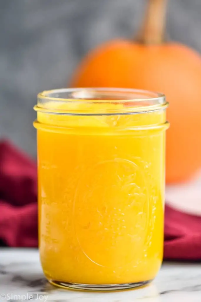 side view of a mason jar full of homemade pumpkin puree