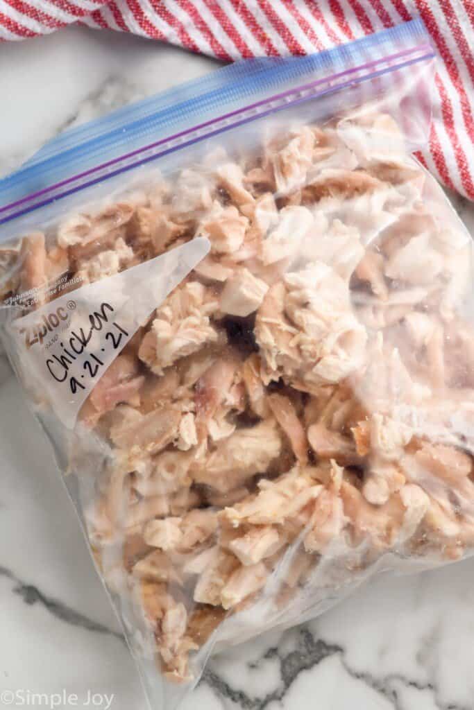 overhead of a ziplock bag full of frozen cooked chicken