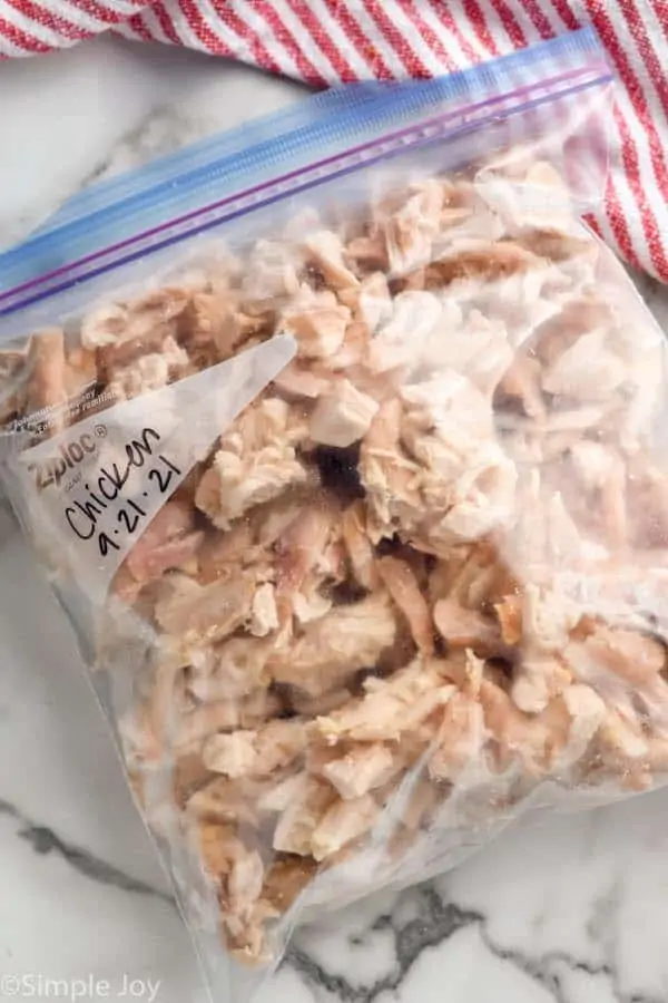 overhead of a ziplock bag full of frozen rotisserie chicken