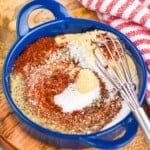 a small blue dish with a small whisk and grill seasoning partially mixed - 8