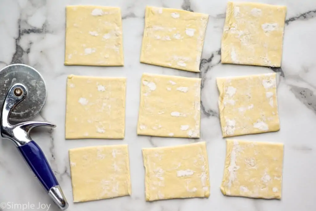 overhead of puff pastry that has been cut into 9 squares