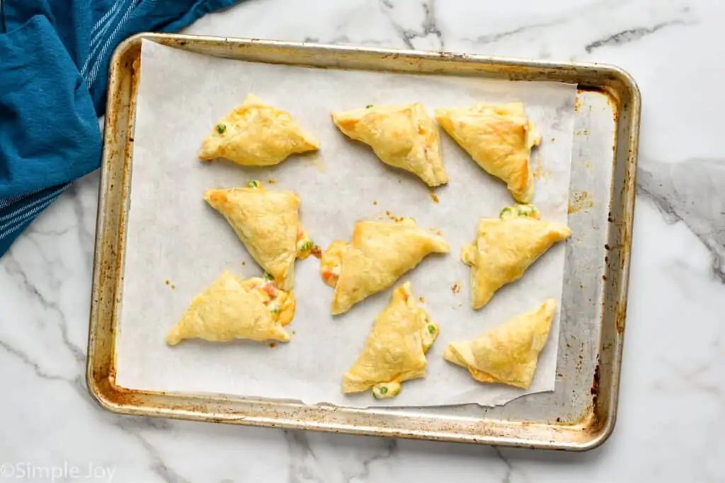 overhead of chicken pot pie hand pies on a baking sheet after baking