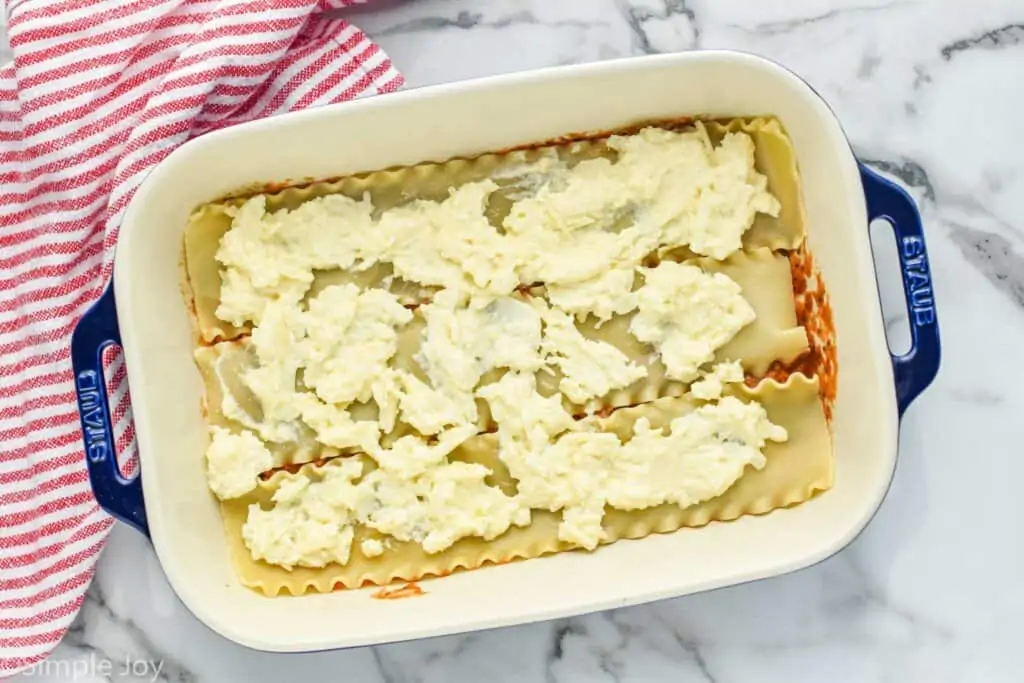 overhead of a baking dish with lasagna noodles and cheese showing how to make a turkey lasagna