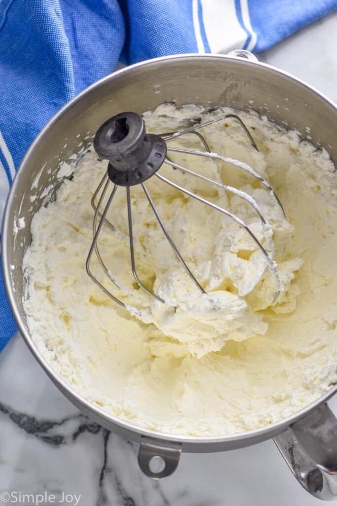 overhead of stabilized whipped ream in a metal mixing bowl with a metal whisk