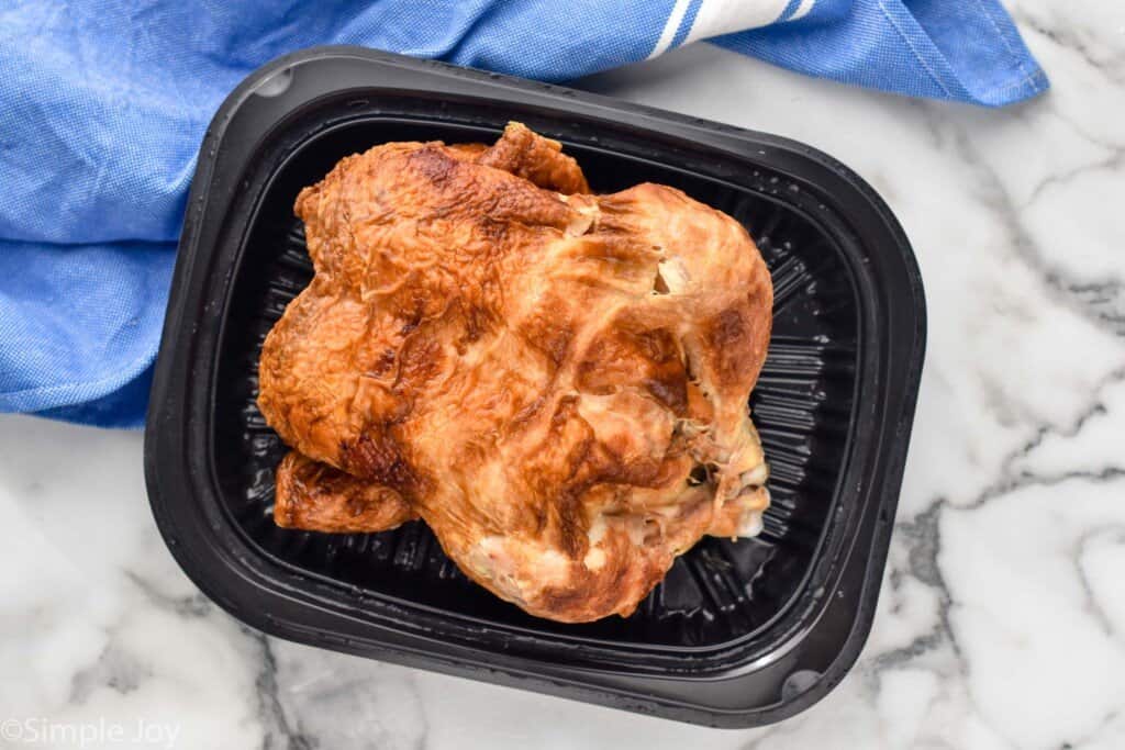 overhead of a rotisserie chicken in a plastic container from the store