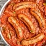overhead of a skillet of sausage and peppers