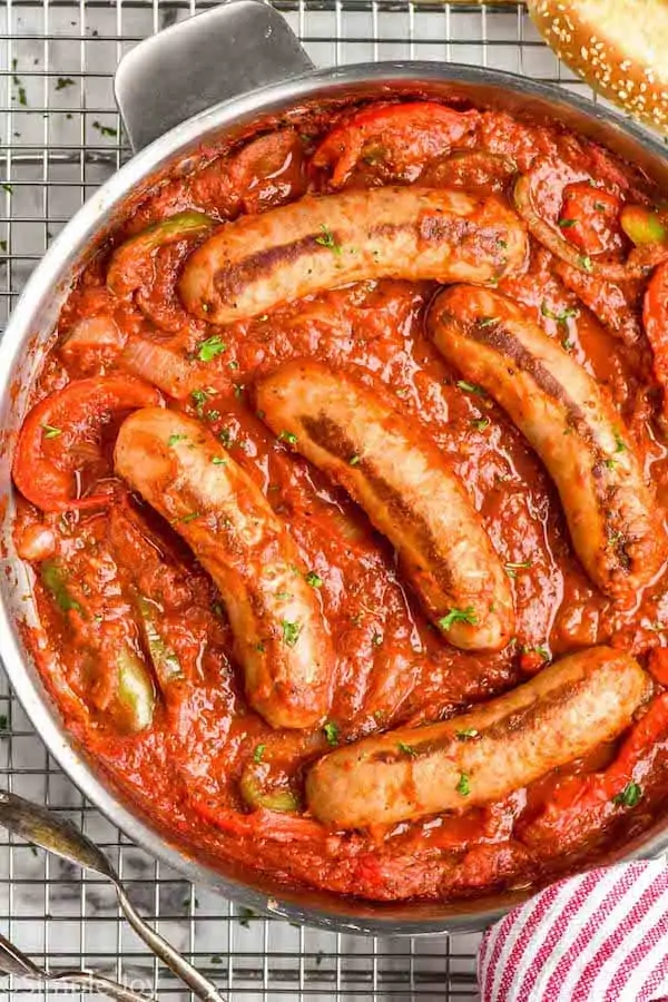 overhead of a skillet of sausage and peppers