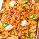 side view of a sheet pan full of shredded chicken nachos - 6
