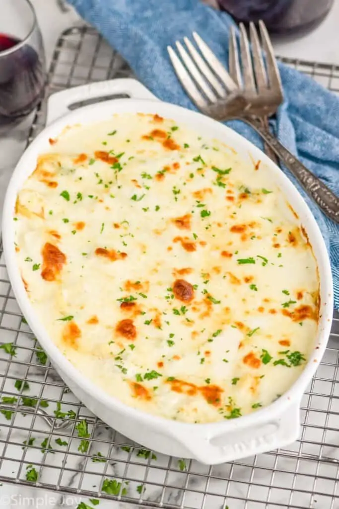 side view of a casserole dish full of stuffed shells with meat