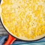 pinterest graphic of overhead of a skillet full of creamed corn