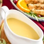 picture of a turkey boat full of gravy sitting on a cutting board