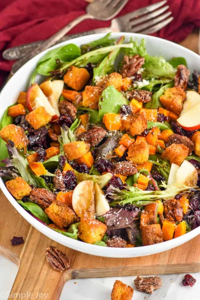 side view of a fall salad with apples, squash, and croutons