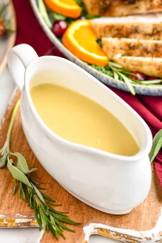 picture of a turkey boat full of gravy sitting on a cutting board