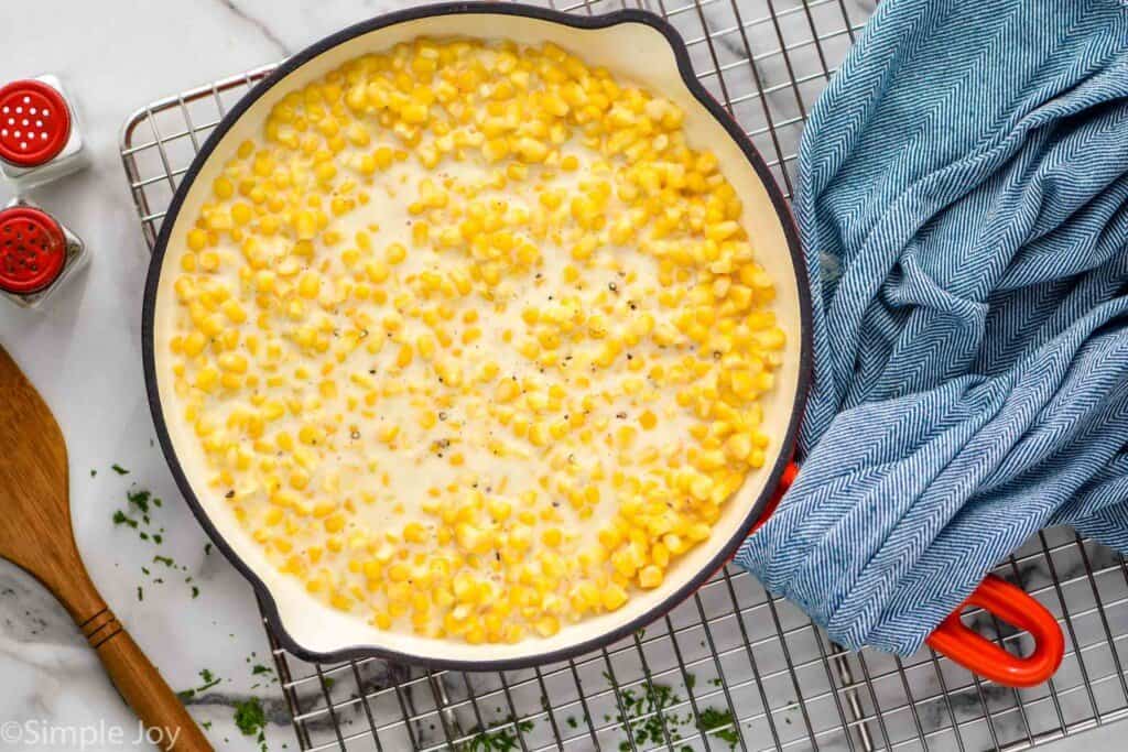 overhead of a skillet full of creamed corn recipe