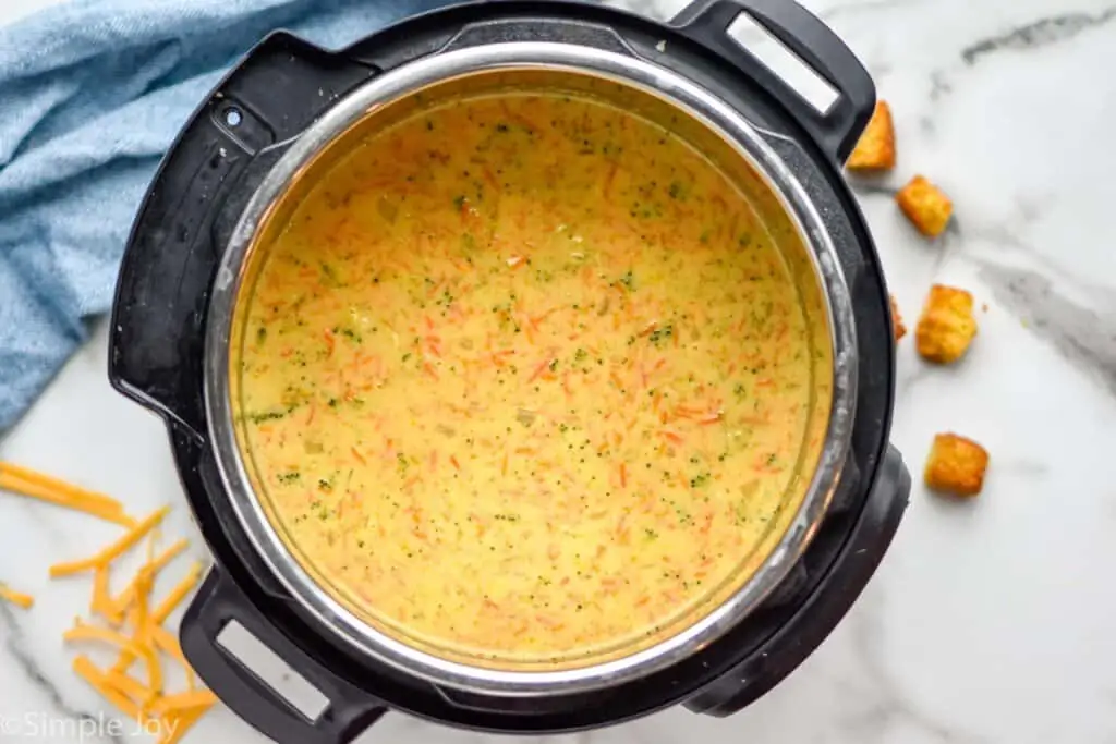 overhead of a pressure cooker filled with broccoli cheese soup