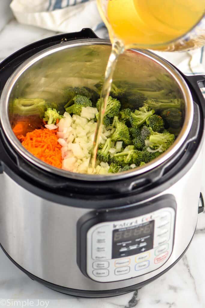 chicken stock being poured into an instant pot to make broccoli cheddar soup