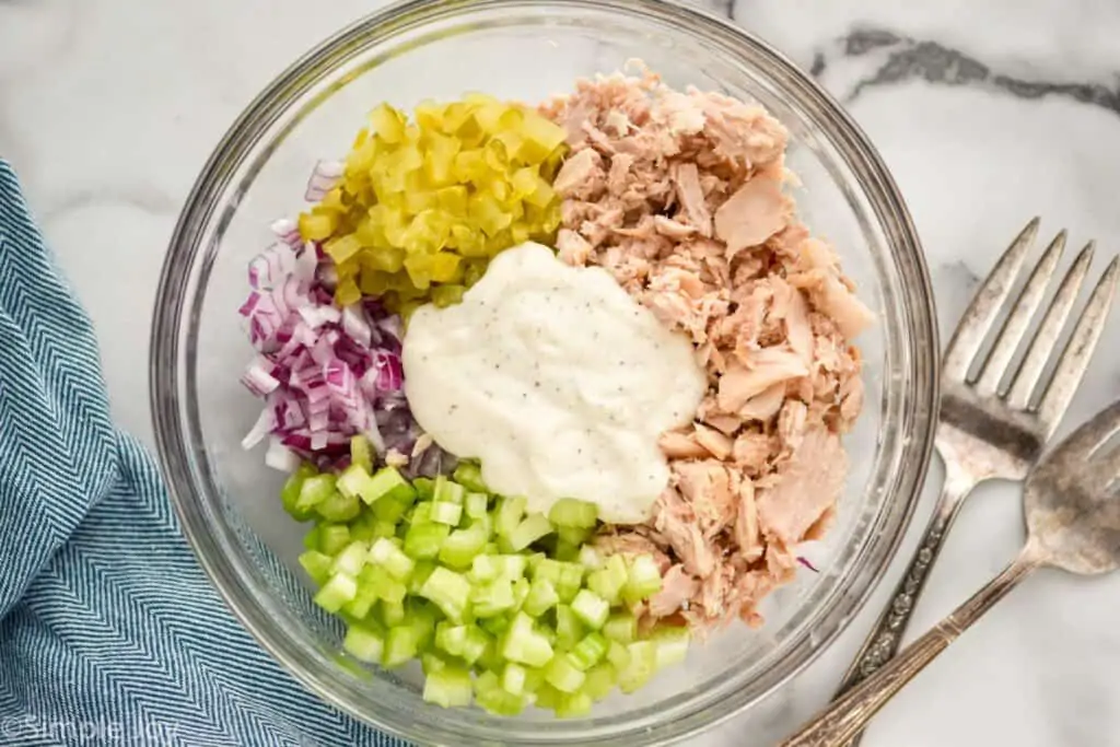 overhead of a bowl of tuna salad broken down by ingredient