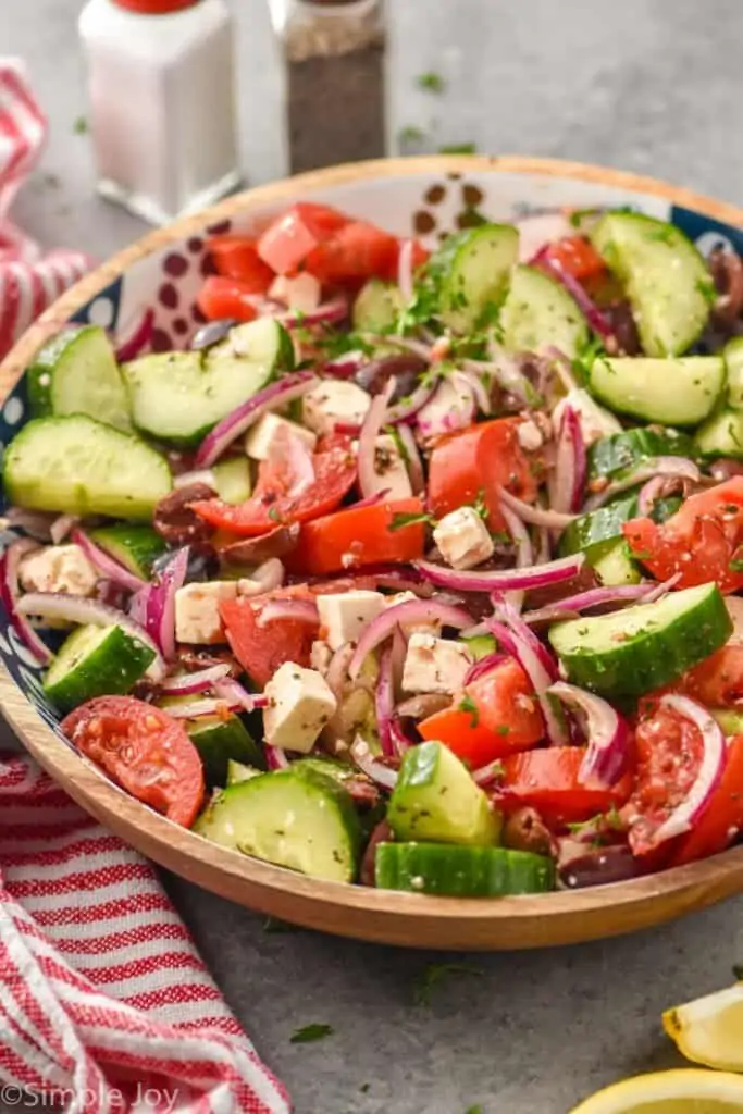 side view of a overhead view of Mediterranean salad recipe in a wooden bowl