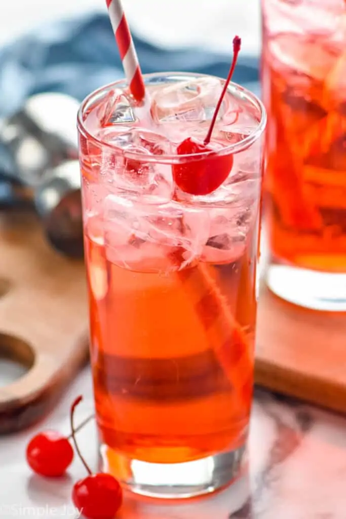 close up of a high ball glass filled with ice and a Shirley Temple