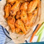 pinterest graphic of overhead of a basket of crispy baked chicken wings