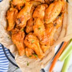 pinterest graphic of overhead of a basket of crispy baked chicken wings