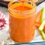 pinterest graphic of spoon dripping buffalo sauce into a mason jar full of it