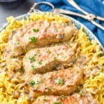 pinterest graphic of four pork chops in a creamy mushroom sauce on a bed of egg noodles