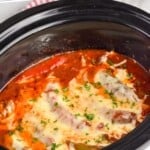 pinterest graphic of side view of a crockpot sausage and peppers recipe in a slow cooker