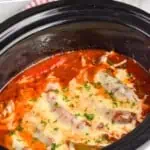 pinterest graphic of side view of a crockpot sausage and peppers recipe in a slow cooker