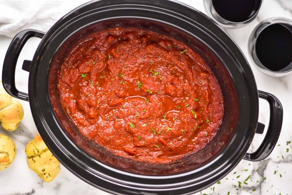 overhead of a slow cooker with crockpot spaghetti sauce recipe in it