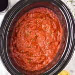 overhead of a slow cooker with crockpot spaghetti sauce recipe in it