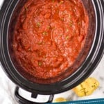 pinterest graphic of overhead of a slow cooker with crockpot spaghetti sauce recipe in it