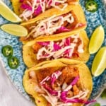 overhead of six fish tacos on a platter