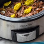 pinterest graphic of a Mississippi pot roast in a crock pot after being cooked and shredded