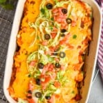 overhead of a casserole dish filled with baked burritos