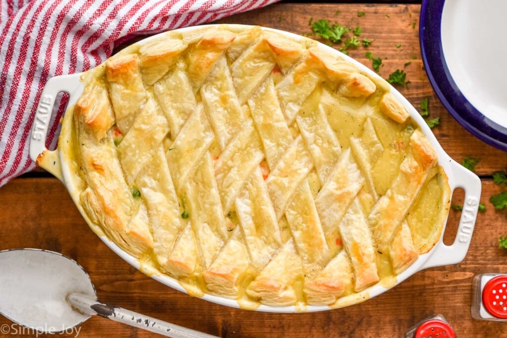 overhead of a casserole dish with a chicken pot pie casserole with a lattice puff pastry top