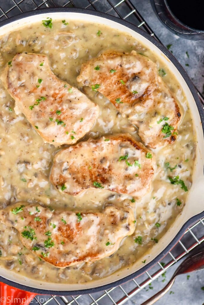 overhead of a skillet with cream of mushroom pork chops