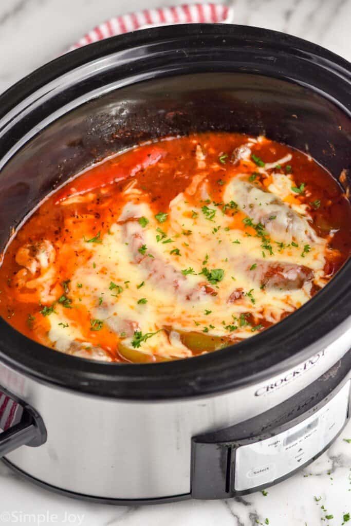 side view of a crockpot sausage and peppers recipe in a slow cooker