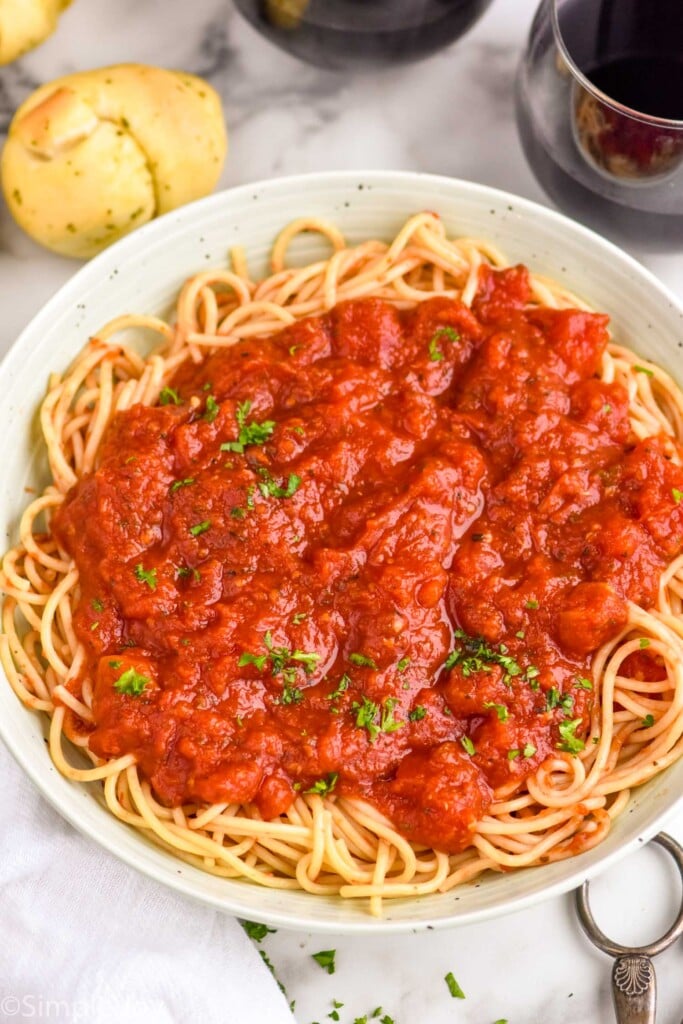 overhead of a bowl of spaghetti with crockpot spaghetti sauce on it