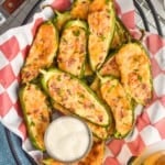 overhead of a basket full of baked jalapeno poppers next to ranch dressing - 11